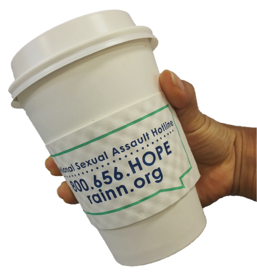 Holding coffee cup with RAINN coffee sleeve, National Sexual Assault Hotline phone number