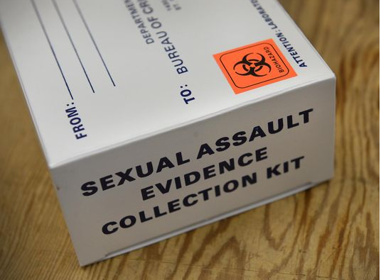 White box with an orange biohazard sticker and a label that reads "Sexual assault evidence collection kit."