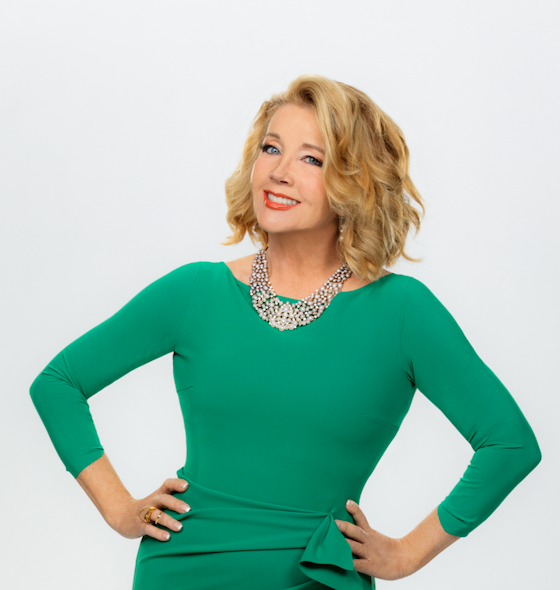 Melody Thomas Scott poses in a green dress